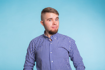 Portrait of a handsome young man against blue background