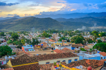 beautiful cozy city surrounded by mountains at sunset