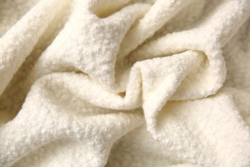 Cotton blanket with an interesting texture and crumpled irregularly in a rather artistic way.

