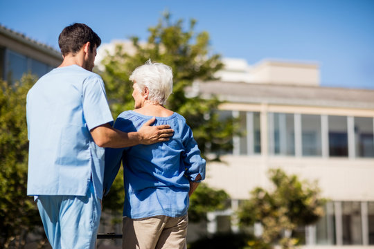 Nurse pushing the senior womans Zimmer frame