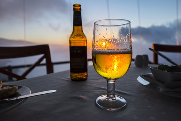 Glass of beer in a sunset setting