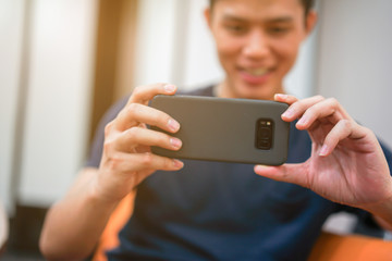 close up hand hold mobile cell phone device:focus on man text on smart phone concept	
