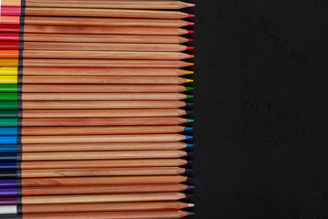 Colour pencils isolated on black background