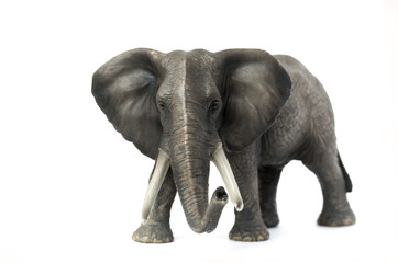 Figurine of a elephant on a white background. Front view