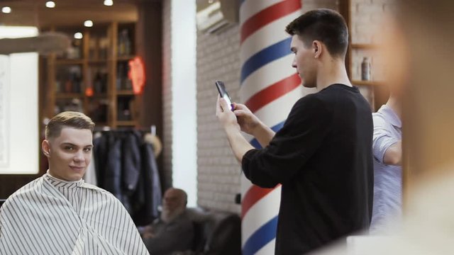 Barber makes photo of new hairstyle