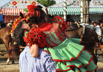 Father with little daughter in the April Fair, Fair in Seville, Spain party