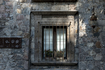 Fototapeta na wymiar Barred window of a house, Zona Centro, San Miguel de Allende, Guanajuato, Mexico