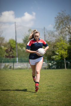 Full length of woman running with soccer ball