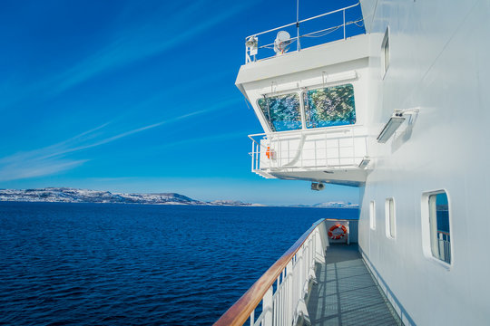 Outdoor view of Hurtigruten cruise trip, view from deck in a gorgeos blue sky and blue water