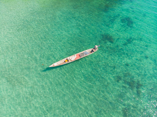 Obraz premium Aerial view of a beautiful tropical island and beach, small fisherman boat on clear blue reef water along Africa, Tanzania, Zanzibar. Indian Ocean