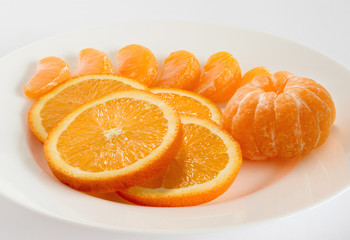 Fresh slices of orange mandarin, the peeled tangerines close up.