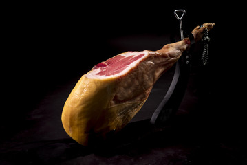 Dry Spanish ham, Jamon Serrano, Italian prosciutto crudo or Parma ham, whole leg isolated on black background