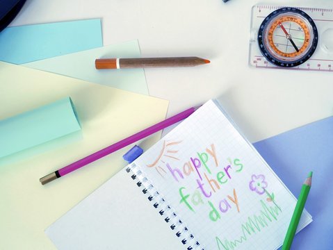 A drawing in a notepad on his father's day, colored pencils on a light background