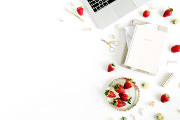 Fototapeta na wymiar Women's workspace with with laptop, notebook, lipstick, fresh strawberry on white background. Flat lay, top view.