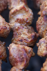 Lovely fresh pieces of smoked meat shish kebab fried on charcoal grill. Roast the meat close up