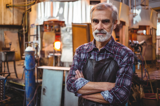 Portrait of glassblower with arms crossed