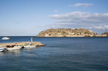 Fototapeta na wymiar Spinalonga Island, Crete, Greece, 2017. The famous former Leper Colony viewed from Elounda coastline in eastern Crete