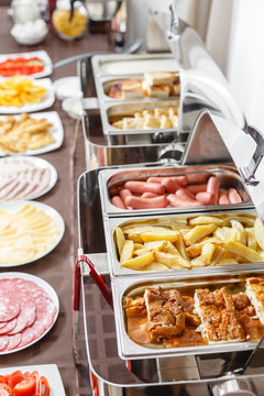 Buffet trays heated ready for service. Breakfast in hotel smorgasbord. Plates with different food