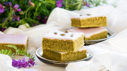 Matcha green tea cakes with white chocolate glaze seeds with tea on the white background