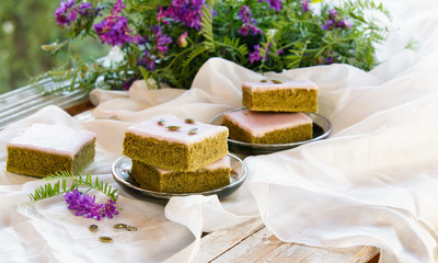 Fototapeta na wymiar Matcha green tea cakes with white chocolate glaze seeds with tea on the white background