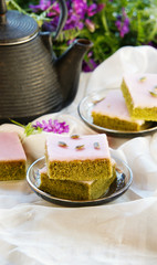 Matcha green tea cakes with white chocolate glaze seeds with tea on the white background