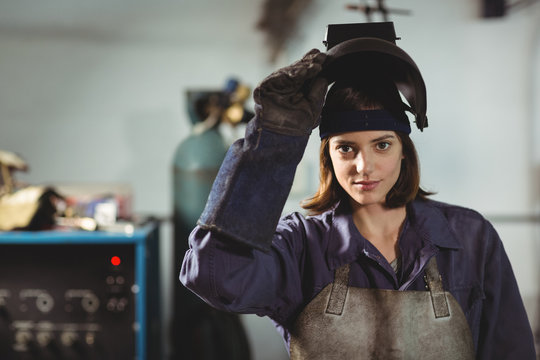 Portrait of female welder standing