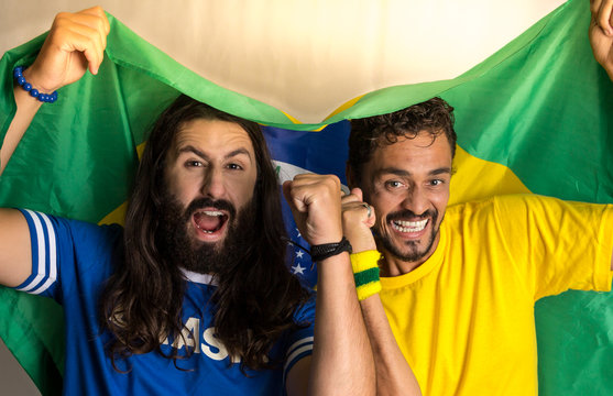 Two brazilian friends celebrating on soccer / football match on white background.