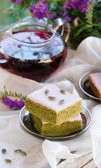 Matcha green tea cakes with white chocolate glaze seeds with tea on the white background
