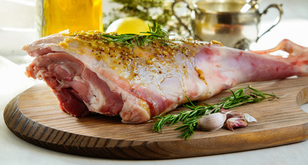 lamb leg raw with olive oil and mustard seeds marinade