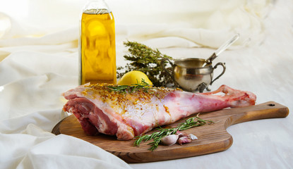 lamb leg raw with olive oil and mustard seeds marinade
