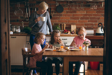 Mother and daughter having breakfast at table