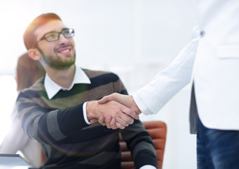 handshake between colleagues in the workplace