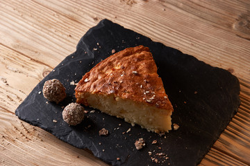 Delicious slice of freshly baked apple pie on shale board