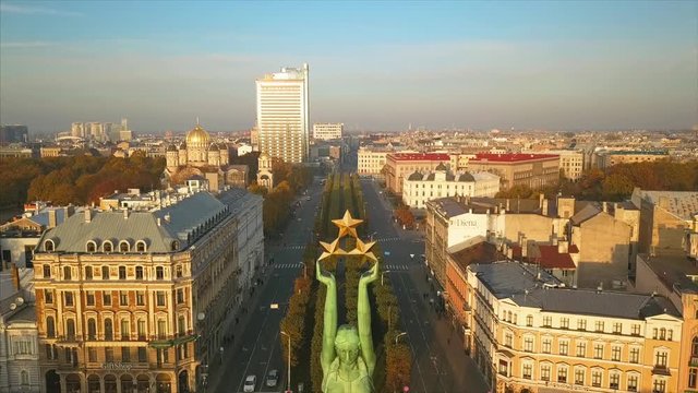 RIGA - 15 SEPTEMBER, 2017: Panoramic View of the Statue of Liberty - Milda in Riga, Latvia, Holding 3 stars Above Her Head, Aerial View of the Riga City during Sunset in Autumn