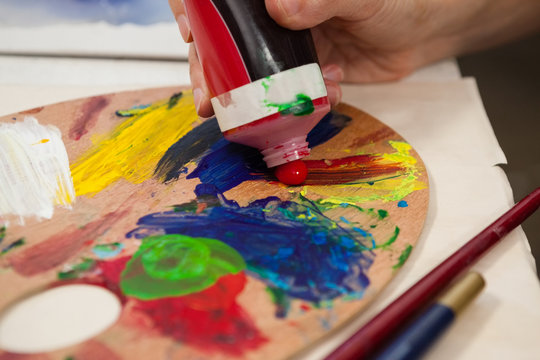 Hand Of Woman Putting Red Color In Palette