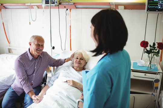 Senior couple interacting with nurse