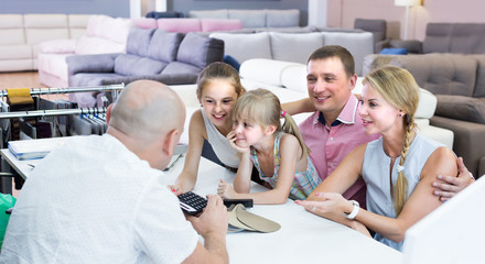 Young family is consulting with the seller
