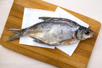The fish lying on a cutting Board. Dried fish.