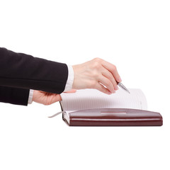 A pen and diary in female hand business woman