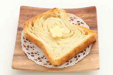 Pastry style sliced bread on wooden plate