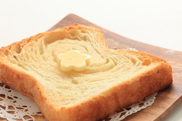 Pastry style sliced bread on wooden plate