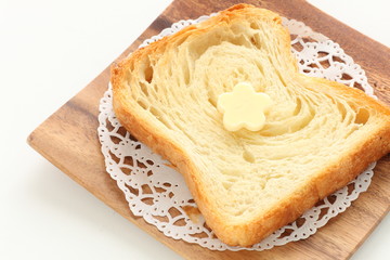 Pastry style sliced bread on wooden plate