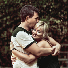 Fototapeta premium Beautiful young couple cuddling and hugging outdoors Couple cuddling and hugging outdoors, cute couple in love.