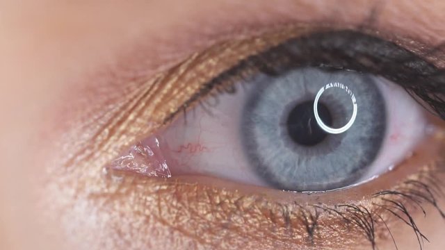 Closeup of female eye with makeup closing and opening - video in slow motion