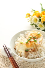 Pan fried quail eggs and soy sauce on rice