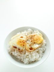 Pan fried quail eggs and soy sauce on rice