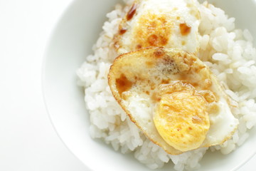 Pan fried quail eggs and soy sauce on rice