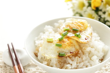 Pan fried quail eggs and soy sauce on rice