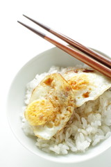 Pan fried quail eggs and soy sauce on rice