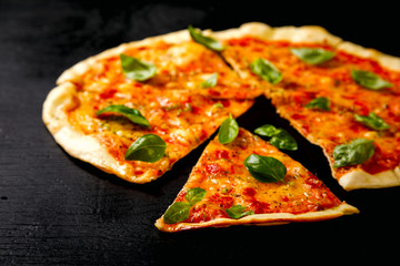 Pizza Margarita with Mozzarella and Basil on the Black Background Bake Snack with Tomatoes  Top View Copy space for Text